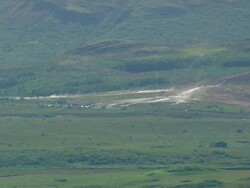 WS AERIAL View of People standing near Strokkur Geyser / Iceland Stock Footage