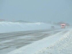 Winter Blizzard with Blowing Snow Across Highway and Ambulance Stock Footage
