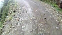 A bicyclist rides a rough dirt track in the Bolivian mountains. Stock Footage