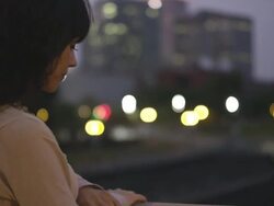 MS R/F PAN Shot of beautiful brunette looks out over city bridges and twilight with city behind her / Portland, Oregon, United States  Stock Footage