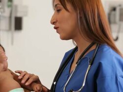 "CU medical worker talking to the mother of an infant hispanic patient/Richmond,Virginia, USA " Stock Footage