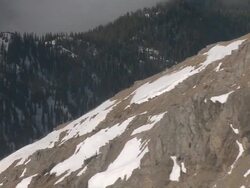 AERIAL WS POV View of grass field on snow mountain behind mountain / Montana, United States Stock Footage