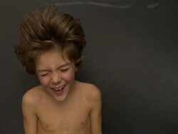 CU SLO MO shot of head and shoulders of caucasian male child on trampoline, lying on back being bounce / Stanford, Connecticut, United States Stock Footage
