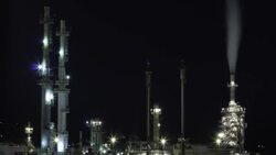 Fumes emit from a smokestack at a petroleum refinery. Stock Footage