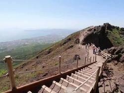 Naples, tourists walking on the mount Vesuvius, bay of Naples on the background Stock Footage