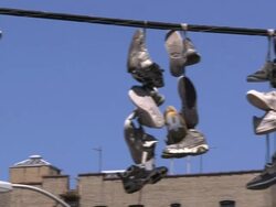 Sneakers hanging from electrical wire Stock Footage