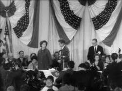 B/W 1960 John + Jacqueline Kennedy standing on platform at victory press conference Stock Footage