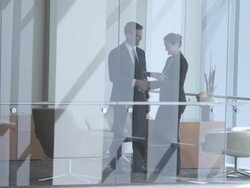  WS Business associates meeting in reception area and looking at electronic tablet, seen through interior windows / Seattle, Washington, United States Stock Footage