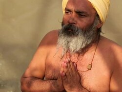 Man worshipping in river ganges, Rishikesh, Uttarakhand, India Stock Footage