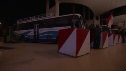 Bus drivers wait near parked buses at a bus station in Saudi Arabia. Stock Footage