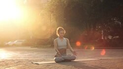 Young Woman Doing Yoga Meditation Exercises at Sunset Stock Footage