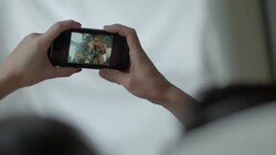 Friends scroll through photos from music festival on smartphone Stock Footage