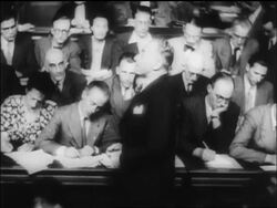 B/W 1945 PROFILE man speaks in courtroom as people in background write / war crimes trial, Paris / newsreel Stock Footage