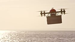 SLO MO UAV carrying a package across sea at sunset Stock Footage