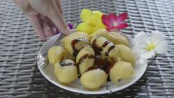 Woman eating fried banana Stock Footage