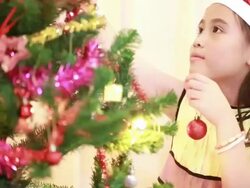Portrait of happy girl decorating Christmas tree Stock Footage