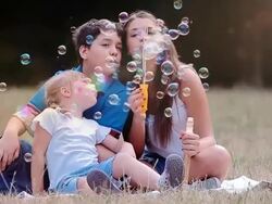 Children blowing bubbles Stock Footage