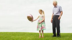 Girl and her Grandfather releasing a helium balloon into the sky Stock Footage