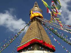 Prayer flags flying from the  Boudhanath Stupa, a place of holy worship, Kathmandu, Nepal, Asia Stock Footage