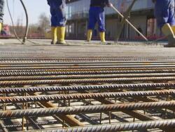 Workers Directing Concrete Onto The Construction Site Stock Footage