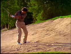 slow motion man hitting golf ball out of sand trap Stock Footage