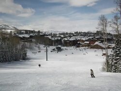skiers skiing down the slopes at a ski resort Stock Footage