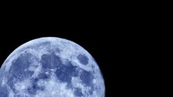 A blue moon travels across the night sky in Valencia. Stock Footage