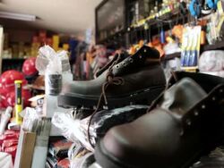 CU R/F Shot of shoes with equipment shop for miners / Potosi, Bolivia Stock Footage