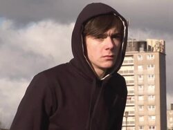 Sad youth with flats behind - HD &amp; PAL Stock Footage