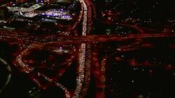 Traffic merges onto freeway from ramp at night. Stock Footage