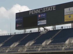 Shot of the large screen in Beaver Stadium at  Pennsylvania State University.  Shot zooms out revealing more of the stadium Stock Footage