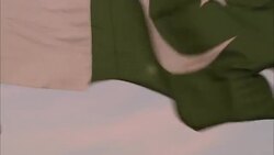 The Muslim-Islamic flag flaps in front of a full moon. Stock Footage