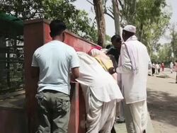 MS Locals at public water source at Raj Ghat Memorial to Mahatma Gandhi / Delhi, Punjab, India Stock Footage