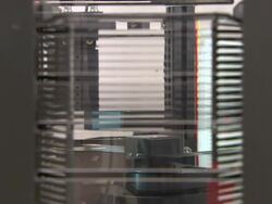 Medium static - A robotic sorter-arm sorts discs and loads them into appropriate slots  Stock Footage