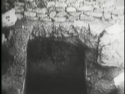 Archaeologist work near the Sphinx and the pyramids as Arab men help remove a large wooden crate from a tomb. News Clip