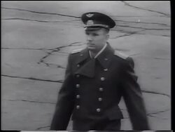 B/W 1961 tracking shot Yuri Gagarin in uniform walking outdoors / first man in space / USSR Stock Footage
