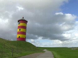 MS Clouds moving over Pilsum Lighthouse near Krummhorn at North Sea (Eastern Friesland) / Lower Saxony Stock Footage