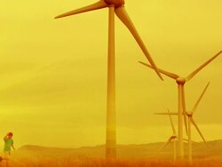 HD SLOW MOTION: Boy in a Field of Wind Turbines Stock Footage