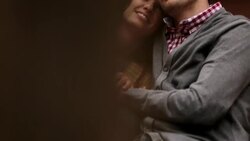 New York couple snuggle close on stoop of brownstone apartment, laughing (dolly-shot) Stock Footage