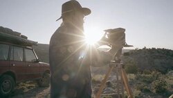 Middle-Aged Caucasian Male Outdoor Photographer Adjusting Camera Stock Footage
