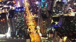 Busy traffic on multiple lane highway and buildings in shenzhen at night,real time. Stock Footage