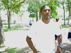 Mid adult African American athletic man stretching before running outdoors Stock Footage