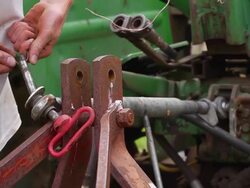 CU SLO MO PAN Shot of hooking up farming equipment up to tractor / Chatham, Michigan, United States Stock Footage