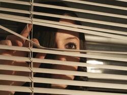 HD CRANE: A girl behind the blinds (Shot on RED) Stock Footage