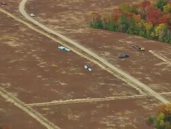 WS ARIEAL View of Truck and bulldozer standing on fields around wooded area / Maine, United States Stock Footage