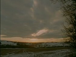 WA time lapse sunset over snow covered countryside, Cotswolds, UK Stock Footage