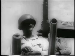 B/W 1959 low angle tilt down soldiers smiling on tank / Cuba / newsreel Stock Footage