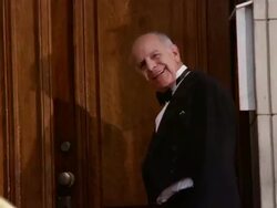 Medium shot portrait of doorman opening door and smiling at CAM Stock Footage