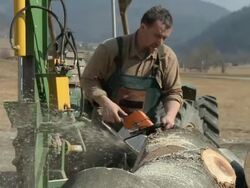 HD SLOW-MOTION: Middle aged man with chainsaw Stock Footage