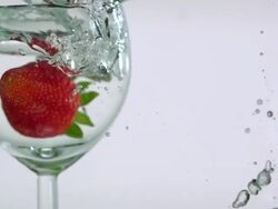 ECU SLO MO Shot of Wine glass and strawberry sinking in water / Toronto, Ontario, Canada  Stock Footage